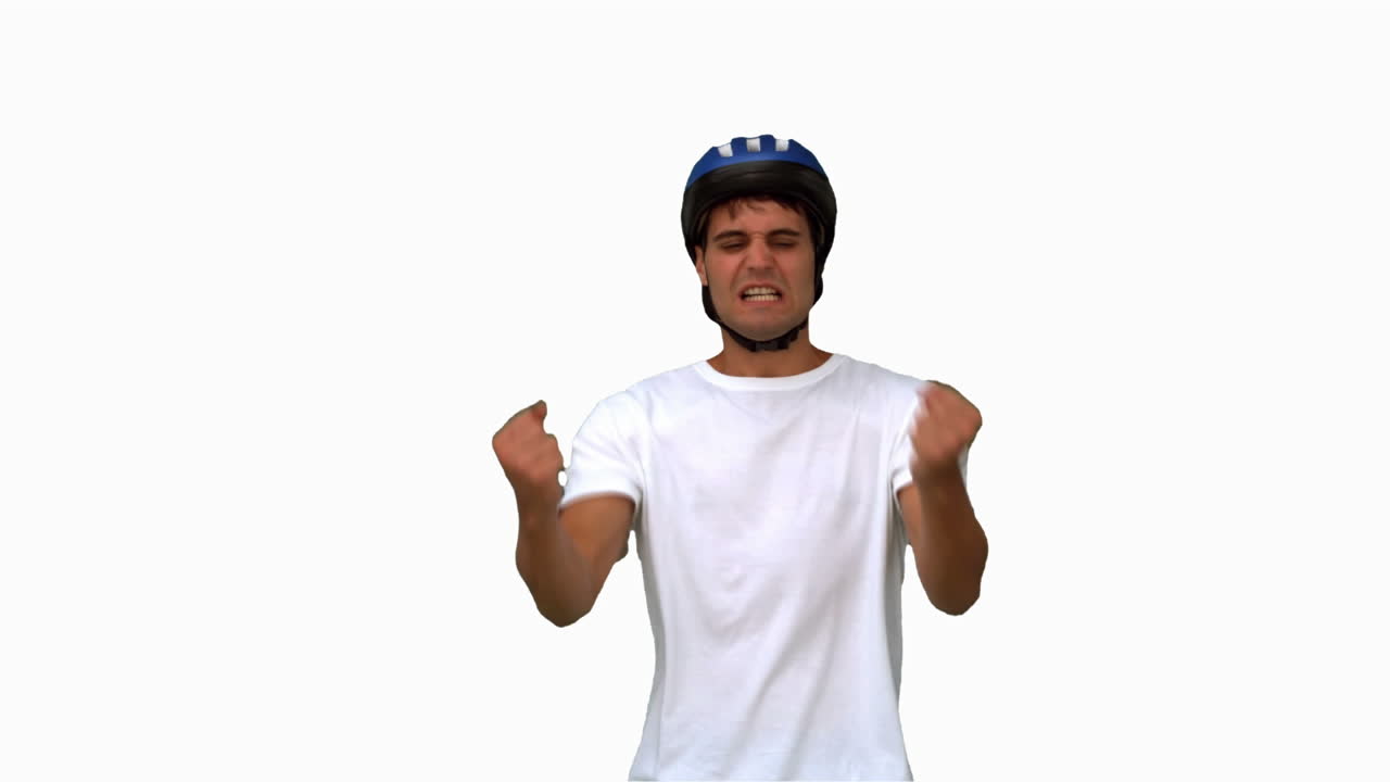 Man wearing a helmet holding his head white screen