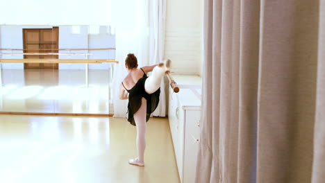 Ballerina-from-the-back-is-doing-exercises-with-a-bar