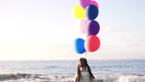 Young-girl-holding-balloons