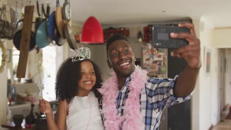 african american father and daughter disguised and taking selfie