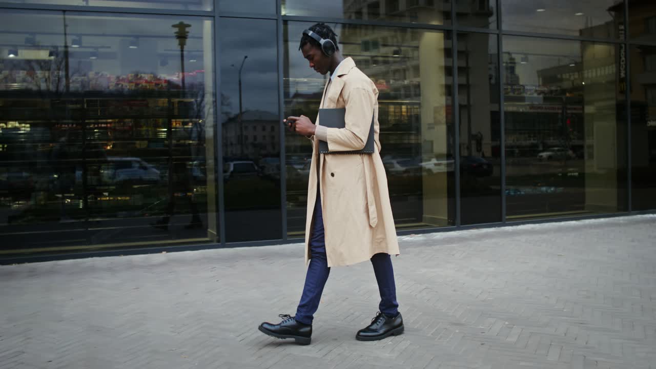 Stylish Man Walking in City with Headphones