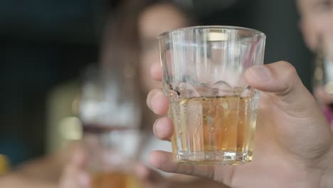 glass of alcohol and friends at the bar