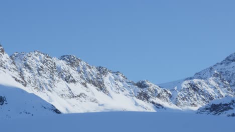 Rocky-ridges-and-snowy-peaks,-high-up-in-the-mountains-of-Tyrol---panorama-view