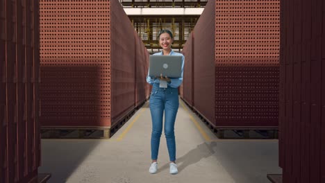 woman working in a brick factory with laptop