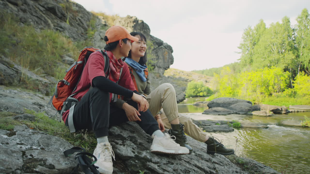 Asian Female Tourists Chatting by River