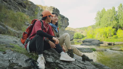 asian female tourists chatting by river