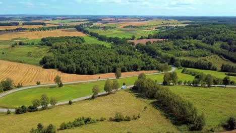 Aerial-Shot-of-Curvy-Country-Road-Surrounded-by-Fields-and-Trees