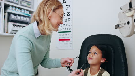 eye exam, optometry and woman with frame for child