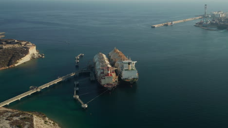 Huge-LNG-Gas-Tankers-Storing-Gas-in-Huge-containers-in-Ocean-before-mediterranean-Island-Malta,-Aerial-Dolly-forward