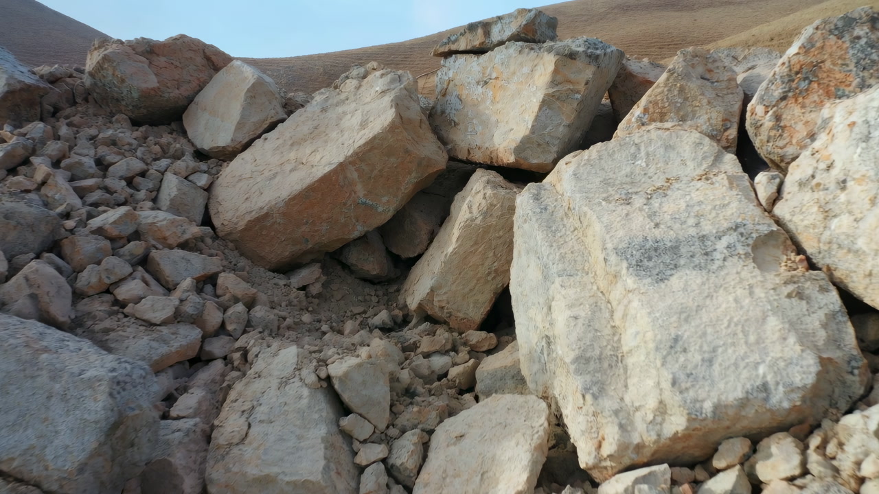 Rocky Boulder Pile On Arid Hillside, Sunlit Quarry Slope With Scattered Stones And Coarse Gravel, Closeup