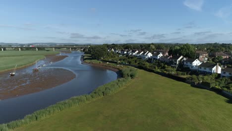 fast rising aerial of the village of topsham, the m5 motorway and the city of exeter in the background