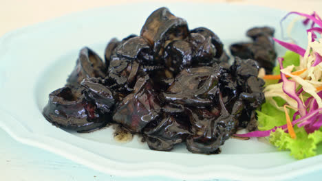 fried squid with squid ink sauce - seafood style