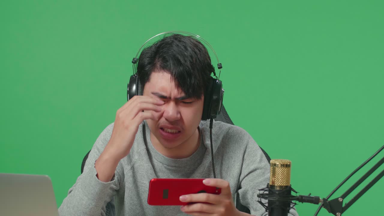 Person Using Headphones, Mobile Phone, and Microphone