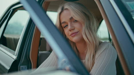 woman in vintage car by the ocean