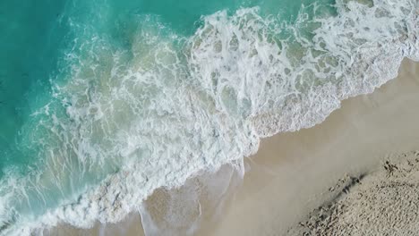 beach with emelard color water beach. sand and waves in caribbean sea coast on the yucatán peninsula. wide aerial shot.