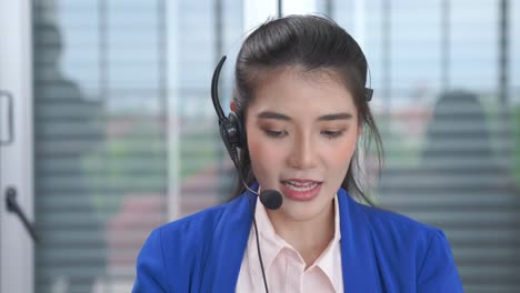 businesswoman wearing headset working actively in office