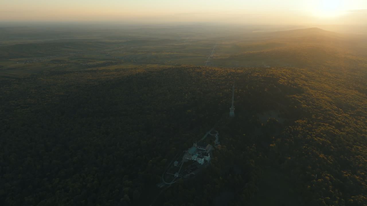 Aerial Sunset View of a Castle Nestled in a Forest