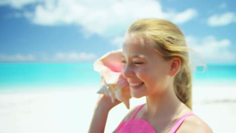 portrait of girl on beach with conch shell