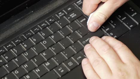 repair of an old laptop, the technician uses a small knife to remove the ctrl key