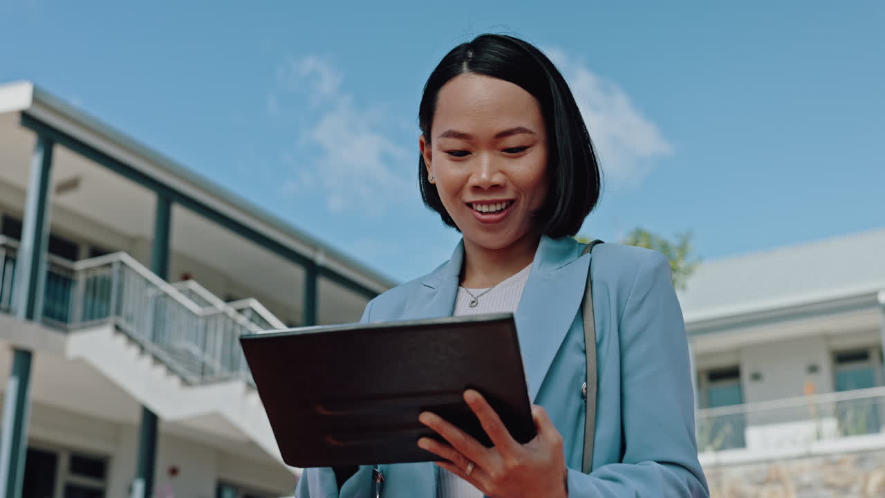 Businesswoman using a tablet outdoors