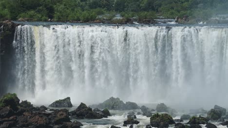 Huge-Bright-Waterfall-Valley-Hidden-in-Large-Green-Jungle,-Amazing-Nature-Scenery-and-Long-Rough-Waterfalls-Falling-on-Green-Coloured-Rocky-Floor-in-Iguacu-Falls,-Brazil,-South-America