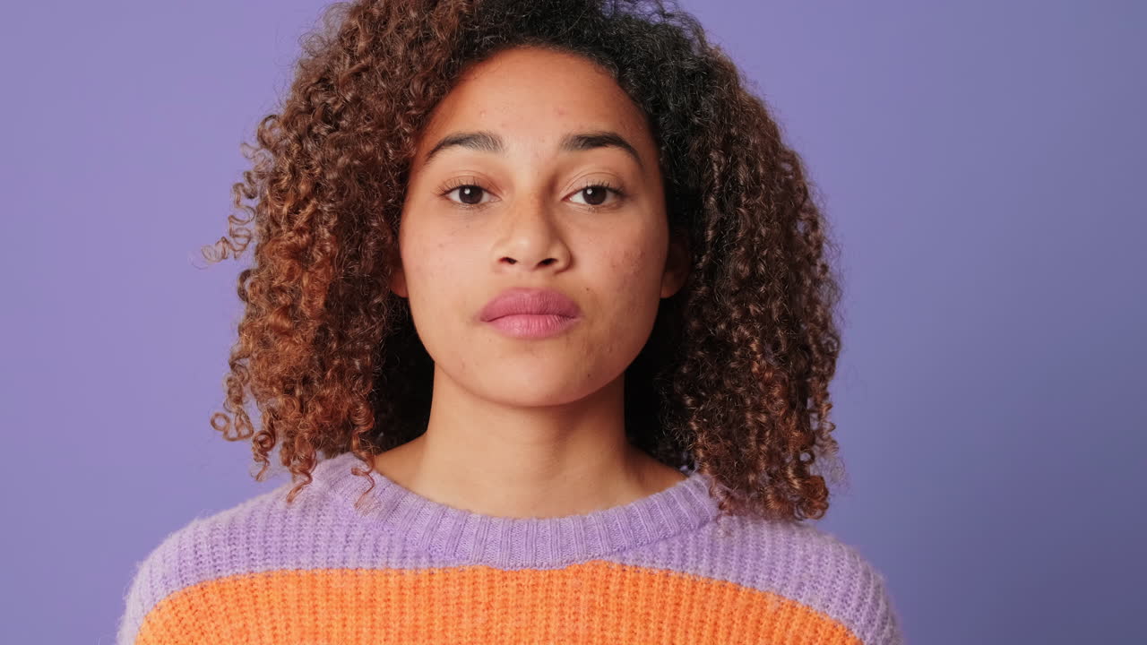 Young Woman with Curly Hair Takes a Deep Breath and Opens Eyes