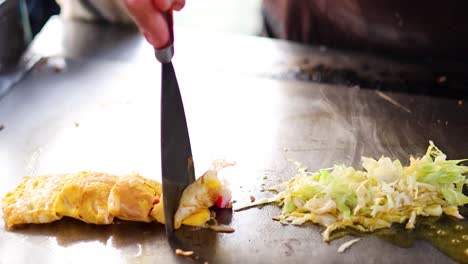 chef preparing a dish on a hot griddle