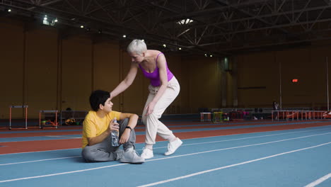 senior woman encouraging tired boy