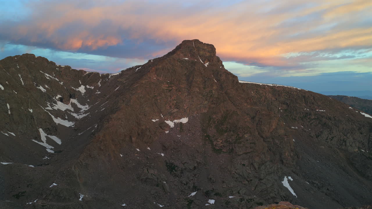 Vibrant sunrise early morning first light on Mount of the Holy Cross 14er peak wilderness aerial drone Colorado North Mountain Shelter Halo Ridge Bowl alpine tundra rocks Rocky Mountain forward pan up