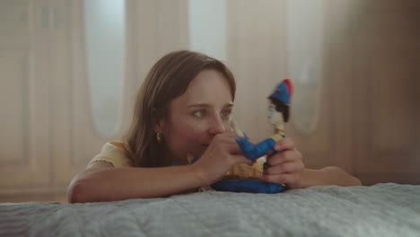 a girl playing with dolls in her room