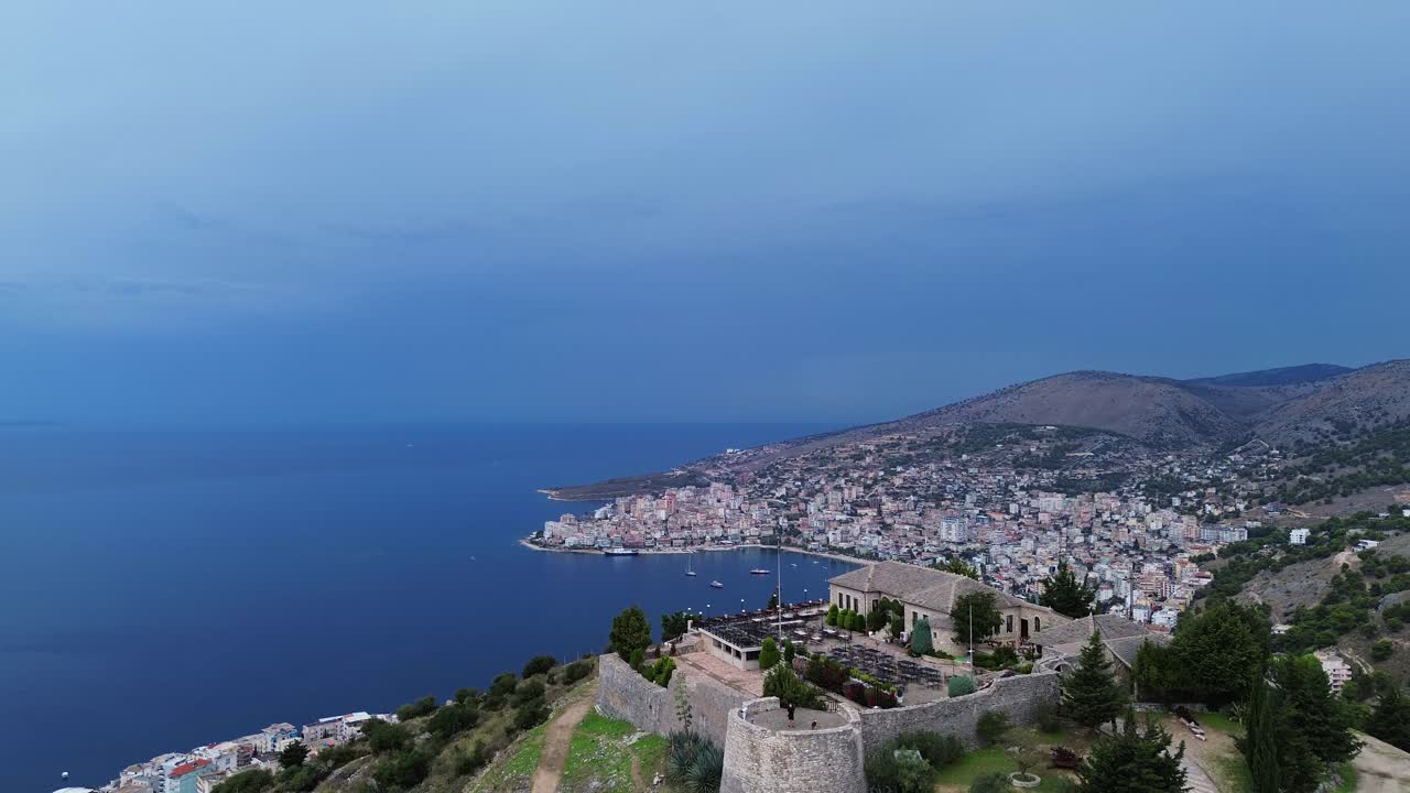 Aerial view of a coastal city with a castle on a hill
