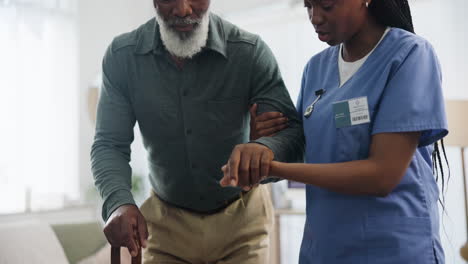 nurse assisting elderly patient with walking