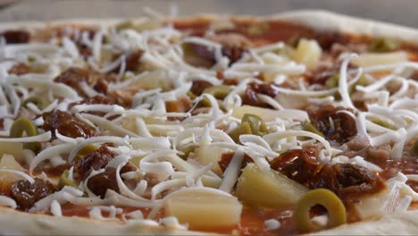 pizza with grated cheese falling on close up view