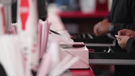 close up food service cashier using cash register