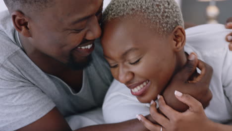 Happy-black-couple,-love-and-care-in-bedroom