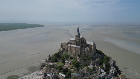 Mont-St-Michael-Tidal-island-Normandy-France-tide-out-pull-back-drone-aerial-reverse-reveal