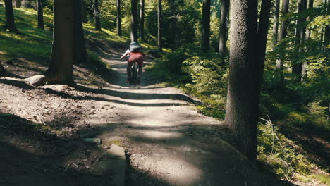 man riding a mountain bike fast down the trail - cinematic moving camera shot