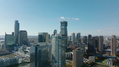 Slide-and-pan-footage-of-modern-high-rise-downtown-buildings-on-Hudson-river-waterfront.-Jersey-City,-USA