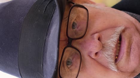 portrait of a grandfather in a hat who adjusts his glasses while standing in an autumn park portrait of a grandfather in a hat who adjusts his glasses while standing in an autumn park