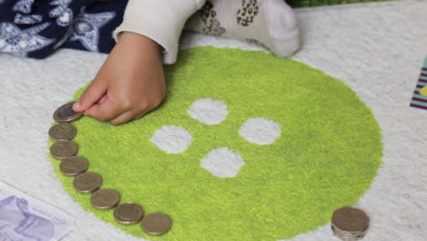 a young child learning about money, close-up soft focus