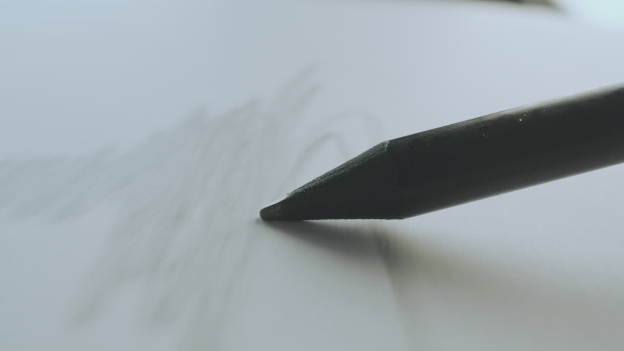 Close-up of a pencil sketching on paper