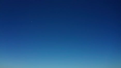 blue sky pan down to reveal the industrial crane ships and the urban city