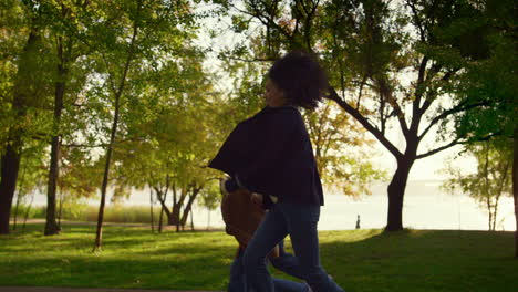 Happy-parents-kid-walking-autumn-city-garden-holding-hands-together-side-view.