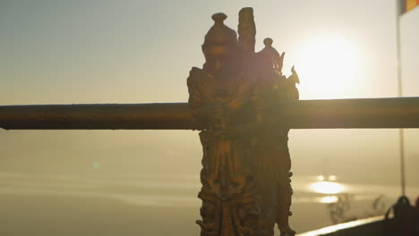 banister-with-buddha-statue-sunset-river-flag-slow-motion