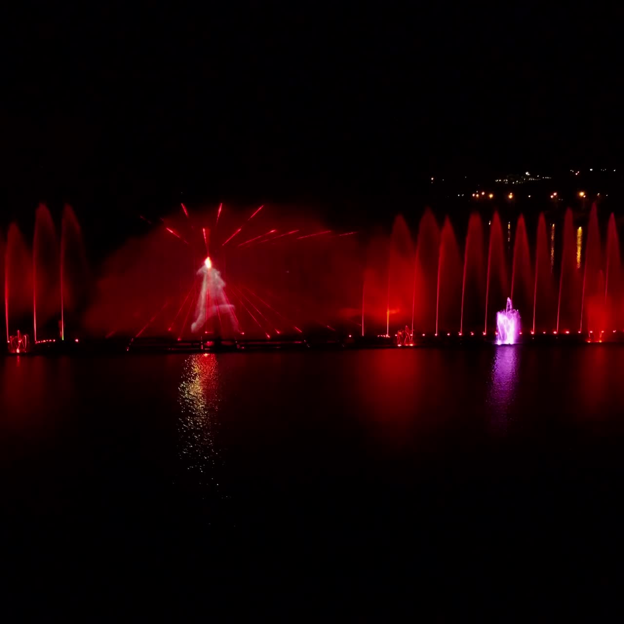Fountain With Colorful Illuminations At Night. Aerial shot of the magic fountain - lights,colors and music spectacle at night