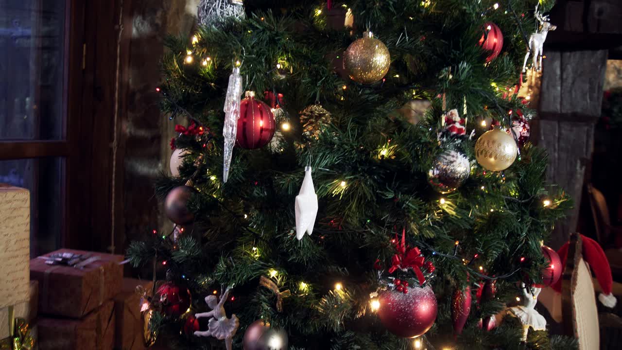 Many gift boxes under beautiful Christmas tree. Decorated christmas tree with bright toys and lights in living room. New Year's time