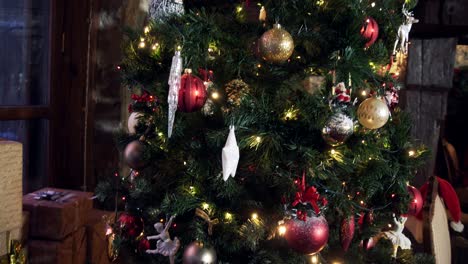 many gift boxes under beautiful christmas tree. decorated christmas tree with bright toys and lights in living room. new year's time