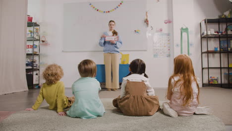 Female-Teacher-Teaching-Words-To-Her-Pupils-In-A-Montessori-School