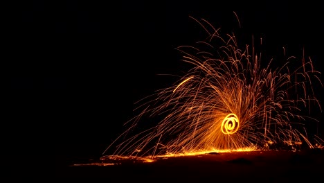 light lines of steel wool with long exposure speed motion abstract at sunrise on the rock