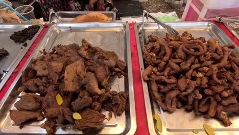 assorted street food displayed on trays